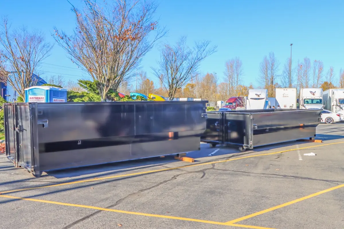 Professional dumpster rental service with roll-off container on residential driveway in Hutto